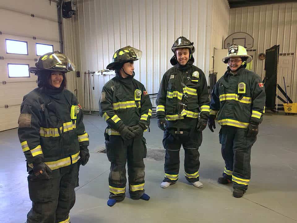 3 teens wearing firefighting gear
